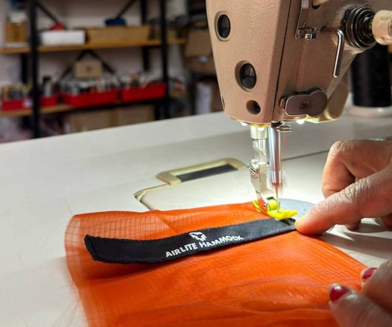 A Yachu label being sewn onto fabric in the Yachu workshop in Nepal