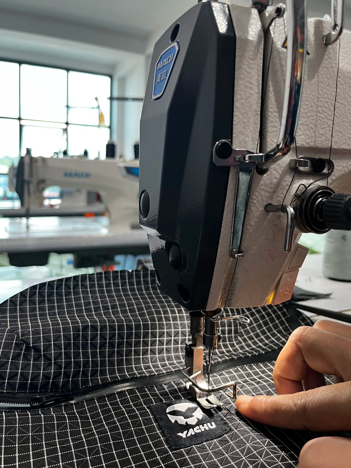 A Yachu label being sewn onto fabric in the Yachu workshop in Nepal