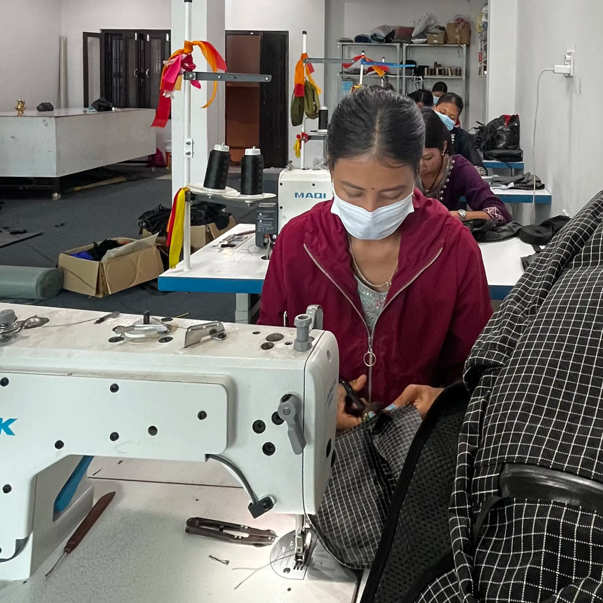 A Yachu label being sewn onto fabric in the Yachu workshop in Nepal